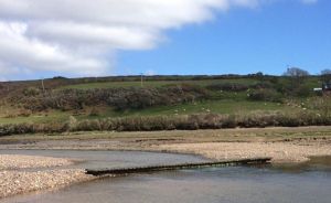 Plank bridge on the coastal walk to Dale at low-tide.